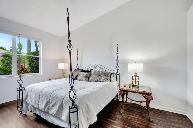 bedroom with lofted ceiling and dark wood-type flooring