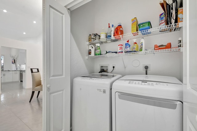 clothes washing area featuring light tile patterned flooring and washing machine and dryer