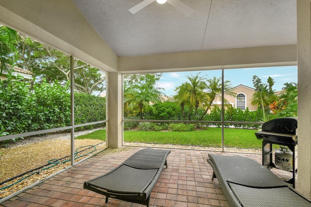 sunroom with ceiling fan and lofted ceiling