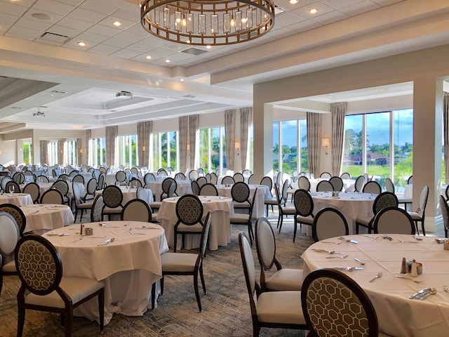 dining room featuring a raised ceiling and a chandelier