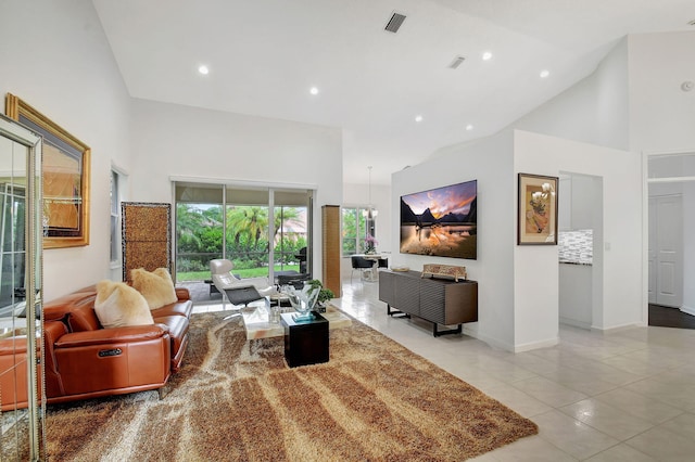 living room with light tile patterned flooring and high vaulted ceiling