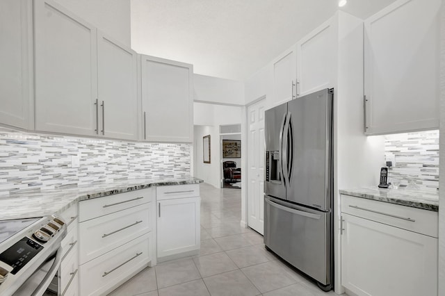 kitchen with light stone countertops, stainless steel appliances, decorative backsplash, and white cabinetry