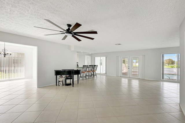 dining area featuring light tile patterned floors, a textured ceiling, visible vents, baseboards, and french doors