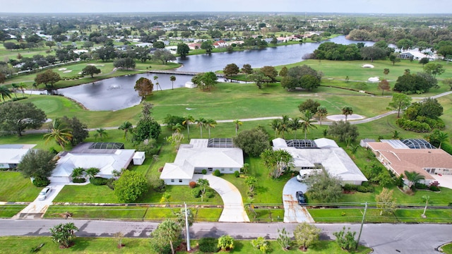 birds eye view of property with view of golf course and a water view