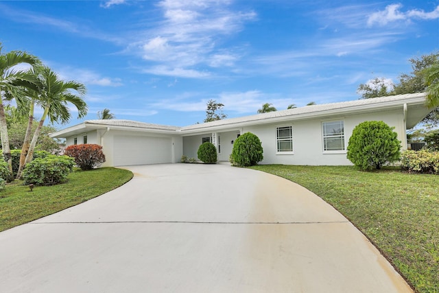 ranch-style house featuring concrete driveway, a front yard, an attached garage, and stucco siding