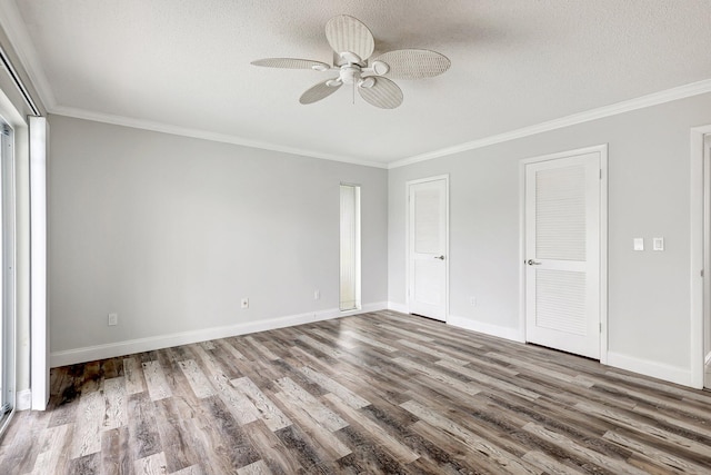 unfurnished bedroom featuring hardwood / wood-style flooring, ornamental molding, and ceiling fan