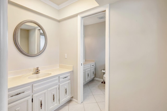 bathroom featuring toilet, tile patterned floors, baseboards, and vanity