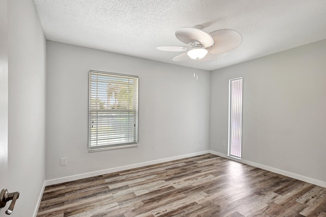 unfurnished room featuring a ceiling fan, a textured ceiling, baseboards, and wood finished floors