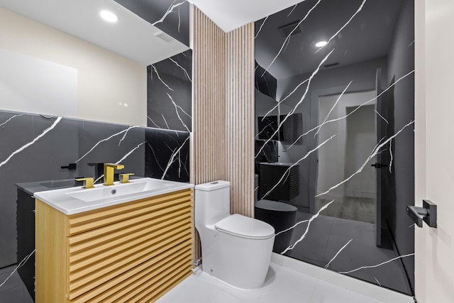 bathroom featuring backsplash, vanity, tile patterned flooring, and toilet