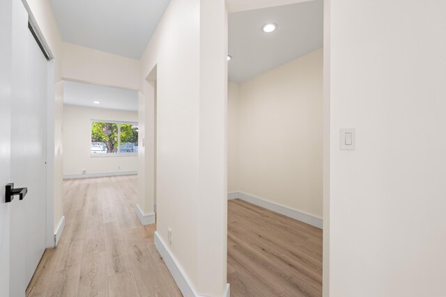 corridor with light wood-type flooring