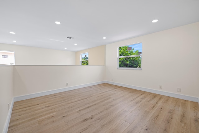 unfurnished room with light hardwood / wood-style flooring