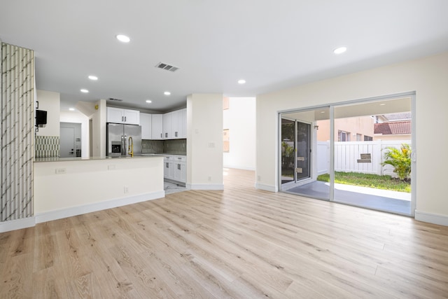 unfurnished living room with light hardwood / wood-style flooring