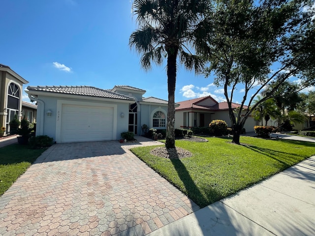 view of front of property with a front lawn and a garage