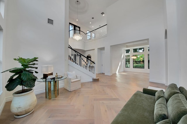 interior space featuring parquet flooring and a towering ceiling