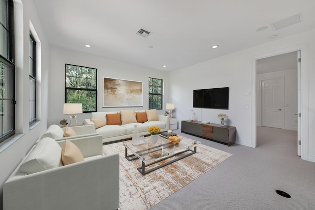carpeted living room featuring baseboards, visible vents, and recessed lighting