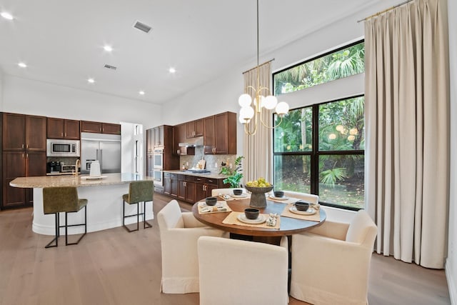 dining area featuring a chandelier and light hardwood / wood-style floors