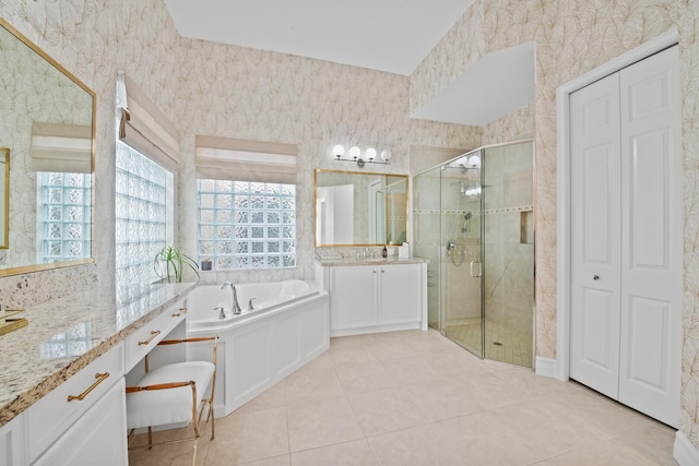 bathroom with shower with separate bathtub, tile patterned flooring, and vanity