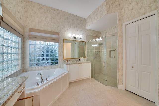 bathroom with vanity, plus walk in shower, and tile patterned flooring