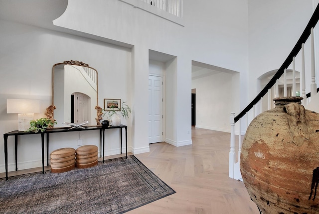 foyer featuring a high ceiling and light parquet floors