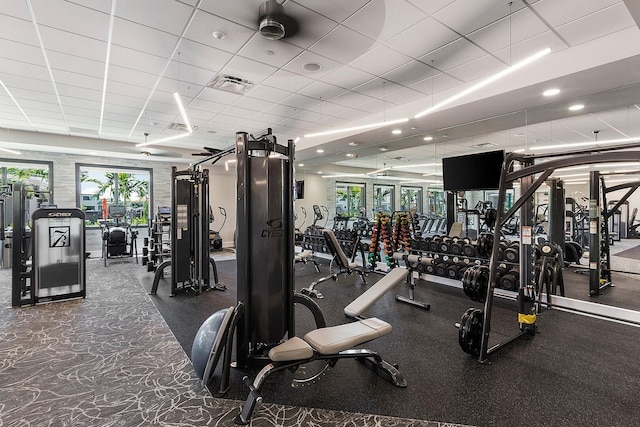 workout area featuring a drop ceiling, recessed lighting, and visible vents