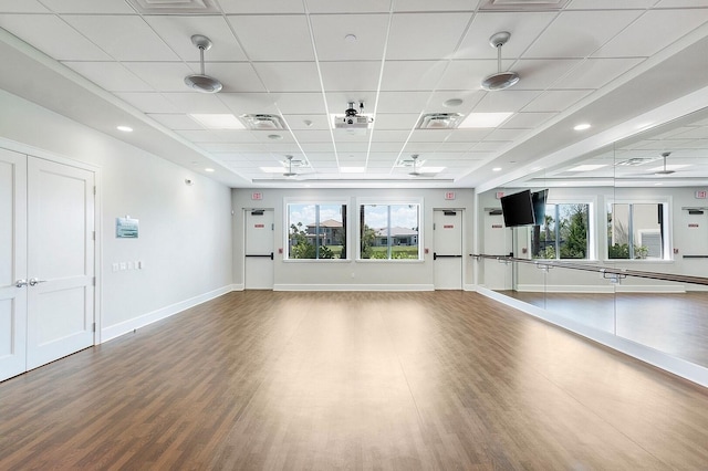 exercise area with plenty of natural light, visible vents, and wood finished floors