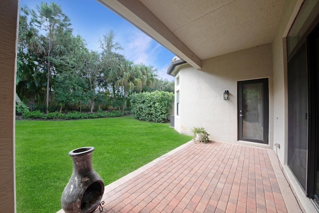 exterior space with a lawn and a patio area