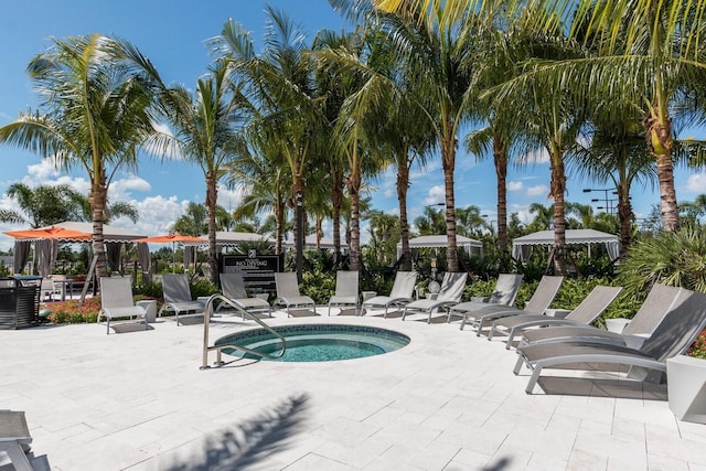 view of swimming pool featuring a patio and a hot tub