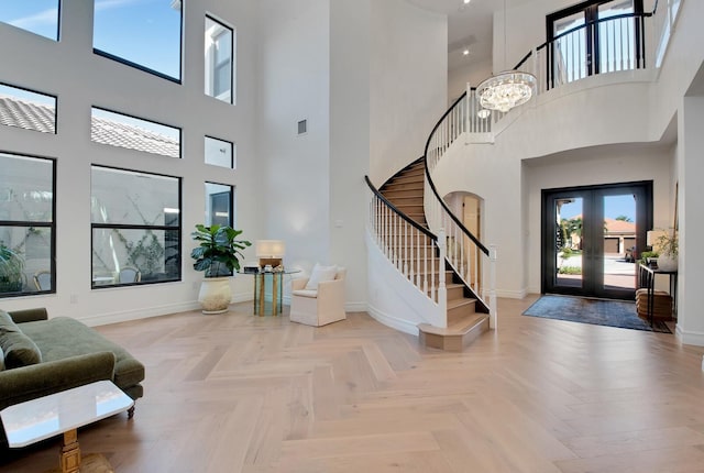 entrance foyer with a chandelier and light parquet flooring