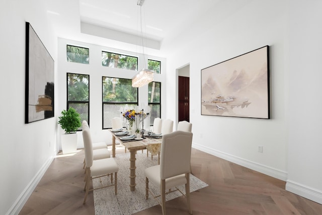 dining space with a high ceiling and baseboards