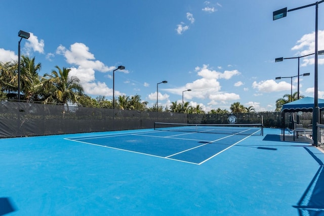 view of tennis court featuring fence