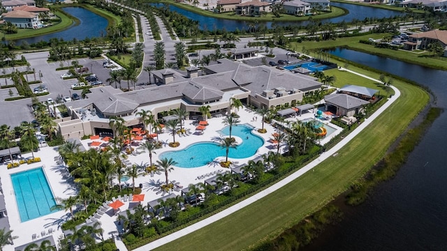 birds eye view of property with a water view and a residential view