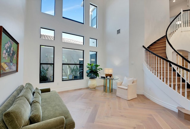 living room featuring parquet flooring and a high ceiling