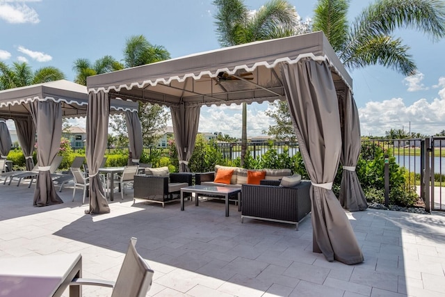 view of patio featuring outdoor lounge area, a water view, and a gazebo