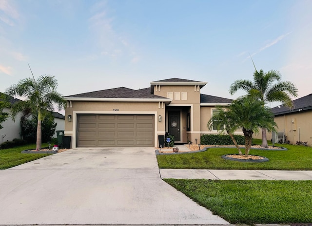 view of front of property with a garage and a front yard