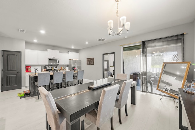 dining room featuring light hardwood / wood-style floors and an inviting chandelier