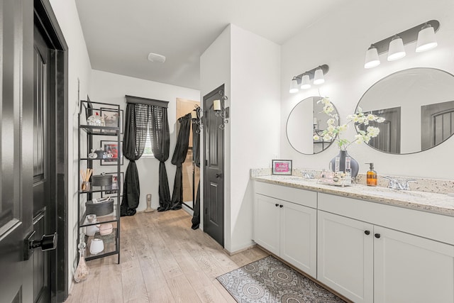 bathroom featuring hardwood / wood-style flooring and vanity