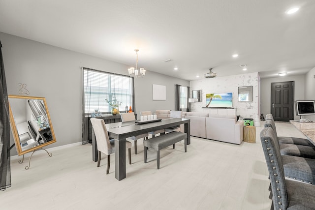 dining space featuring a chandelier and light hardwood / wood-style floors