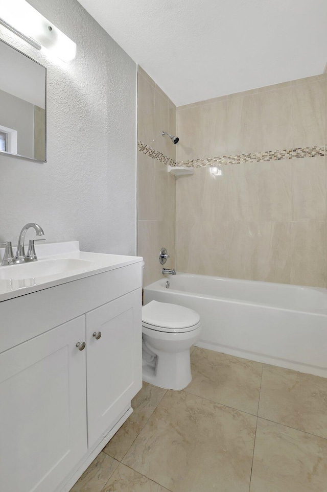 full bathroom with tiled shower / bath combo, tile patterned flooring, vanity, and toilet