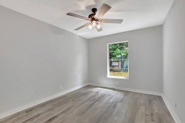 empty room featuring ceiling fan and light hardwood / wood-style flooring