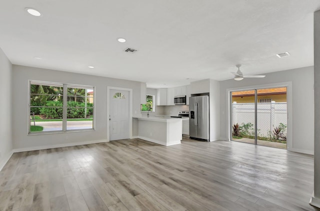 unfurnished living room featuring light hardwood / wood-style floors and ceiling fan