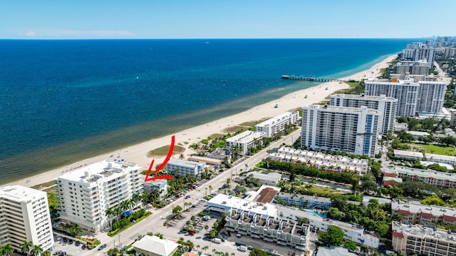 bird's eye view with a water view and a beach view