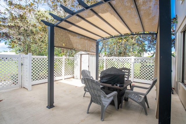 view of patio / terrace with a pergola and a shed