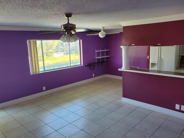 tiled spare room featuring a textured ceiling and ceiling fan