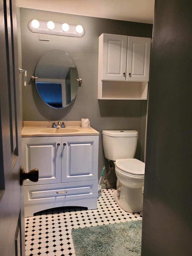 bathroom featuring tile patterned flooring, vanity, and toilet