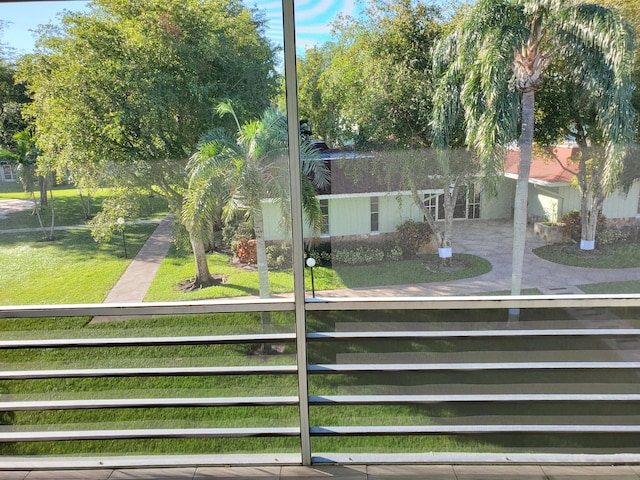 view of front of property featuring a balcony and a front lawn