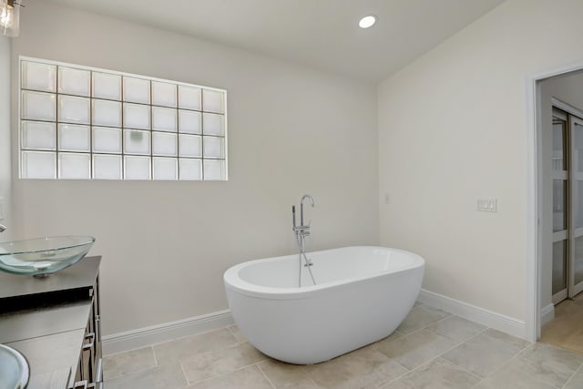 bathroom with a tile shower, vanity, and toilet