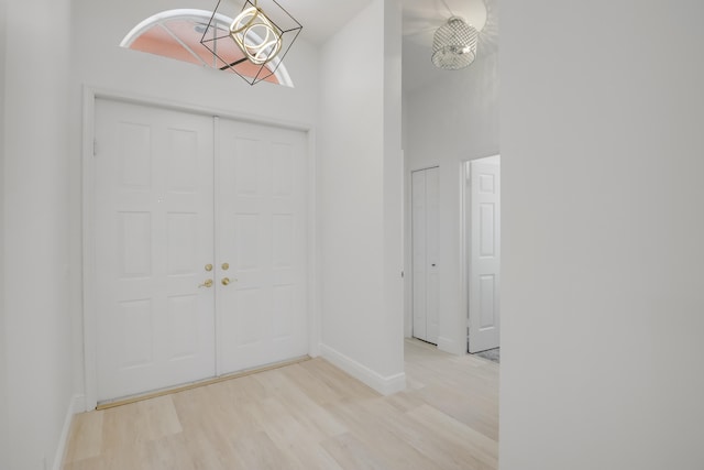 entrance foyer featuring light hardwood / wood-style flooring and a high ceiling