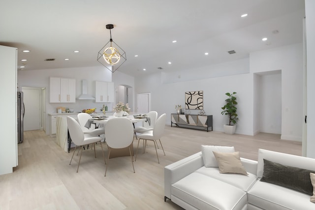 kitchen with black dishwasher, stainless steel fridge with ice dispenser, vaulted ceiling, white cabinetry, and light stone countertops