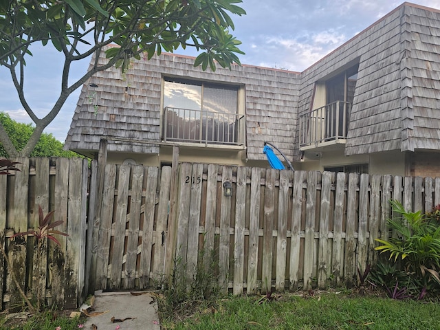 rear view of property featuring a balcony