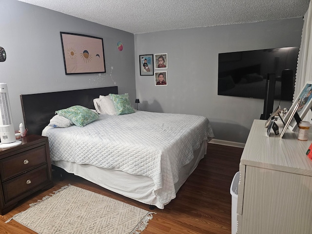 bedroom featuring hardwood / wood-style flooring and a textured ceiling